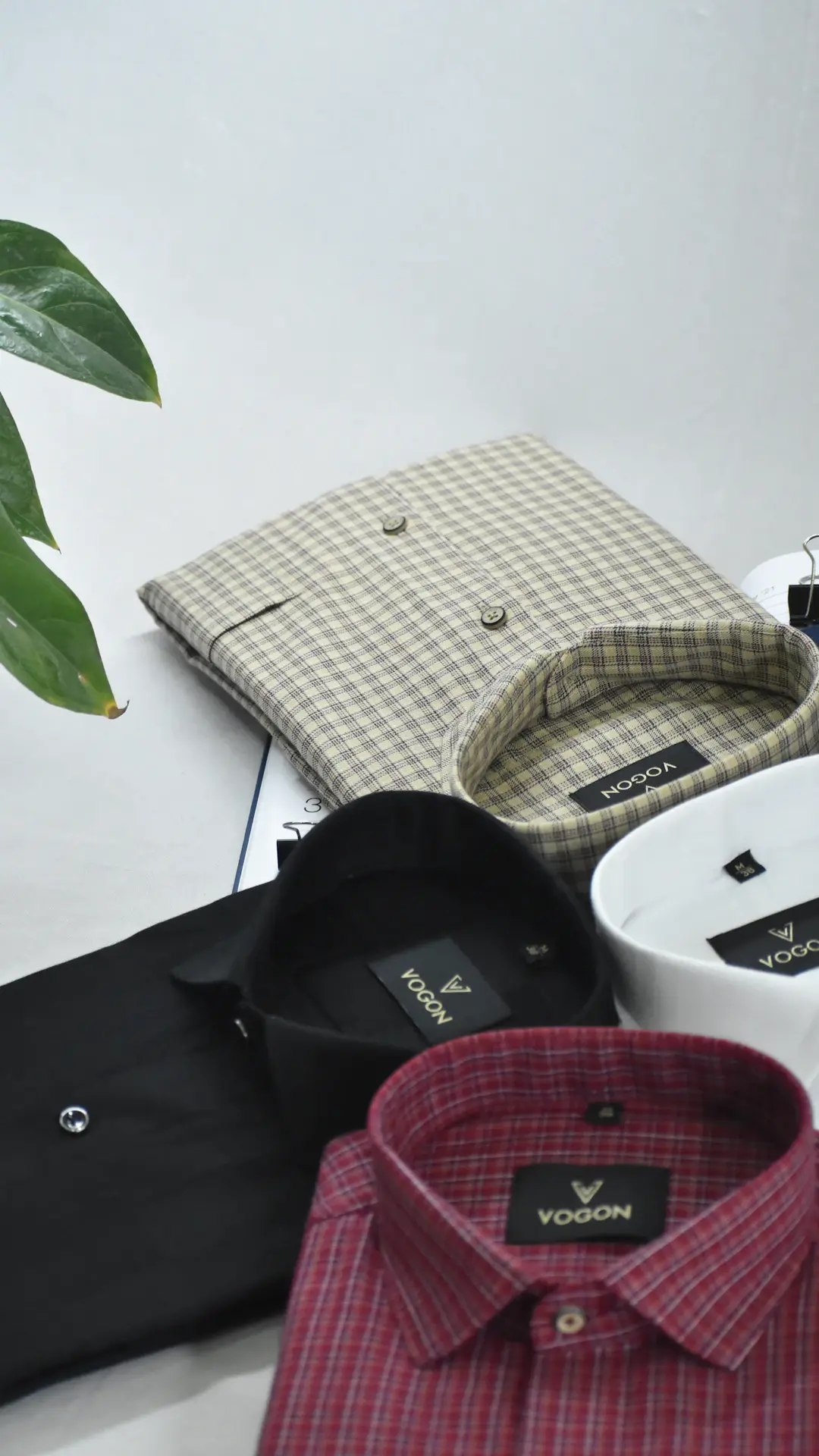 a white table topped with lots of different types of shirts